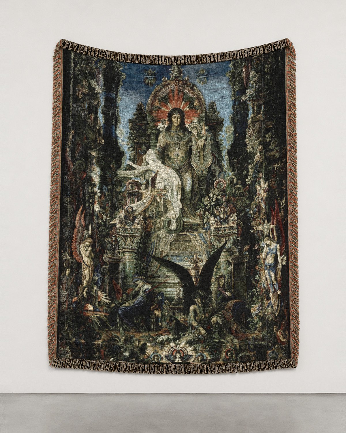 Jupiter and Semele woven blanket hung on a white gallery wall: an enthroned god in a jeweled architecture of plants and figures.